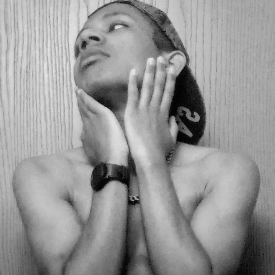 Dfame in black and white, hands resting against his face